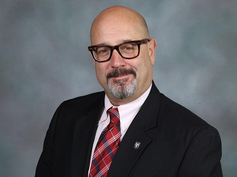 Professional man in glasses wearing a suit and tie.