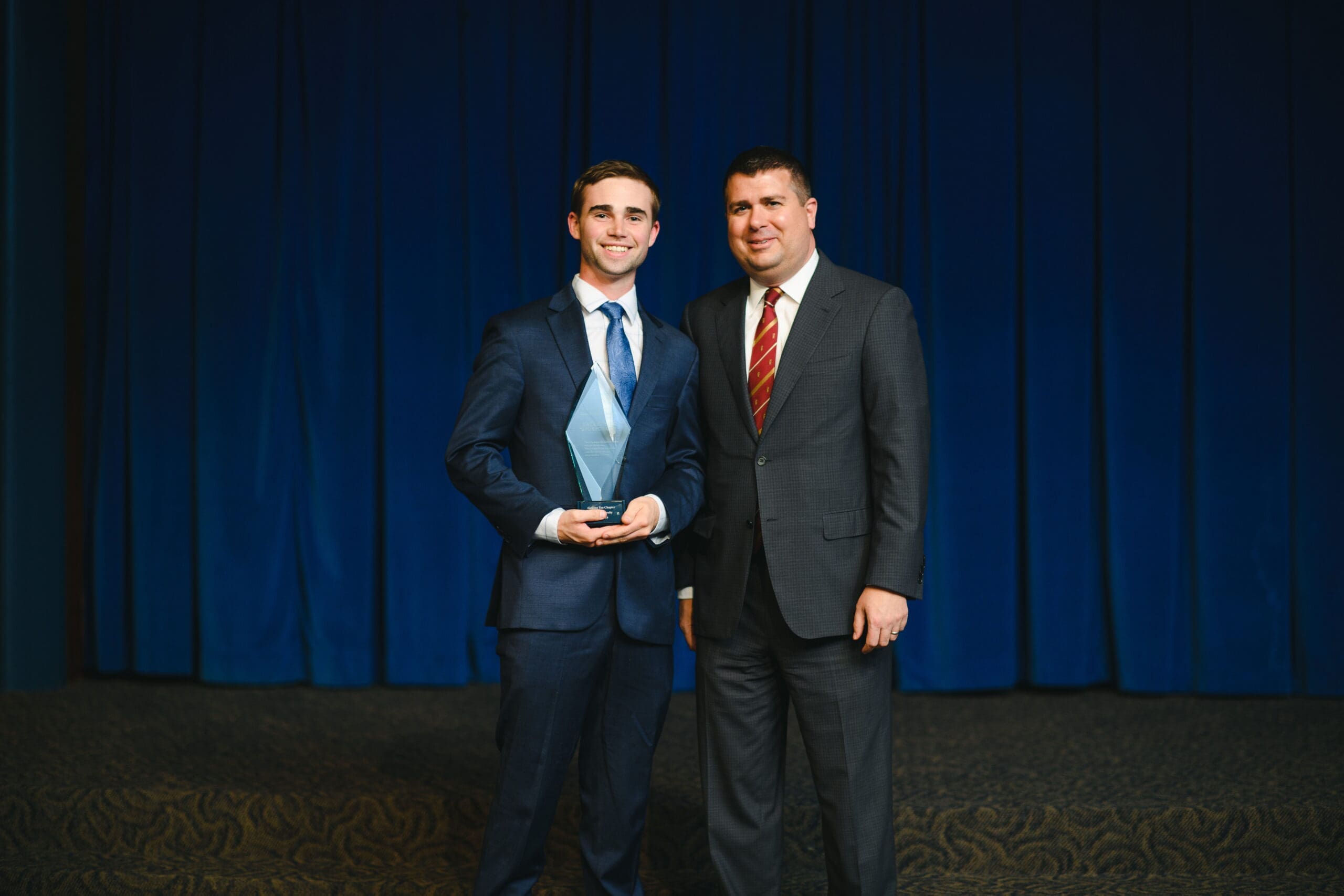 2018/2019 Sacred Purpose Award Award ceremony with two men in suits.