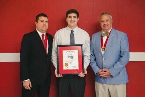 Students receiving award with school officials.
