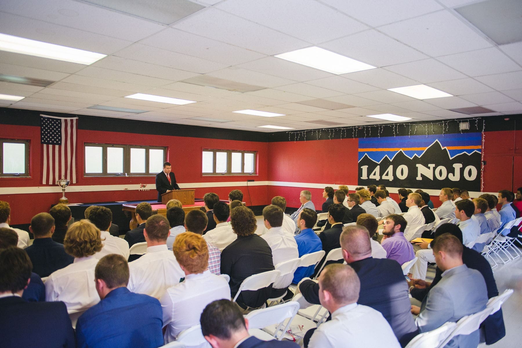 Men listening to a speaker at a conference.
