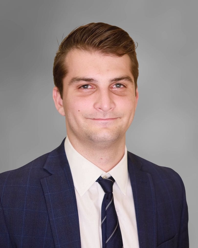 Professional man in suit with friendly smile.