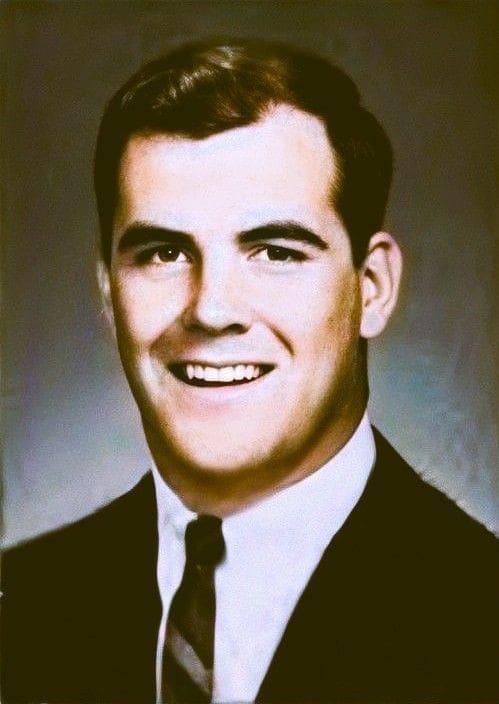 Smiling man in a suit and tie portrait.