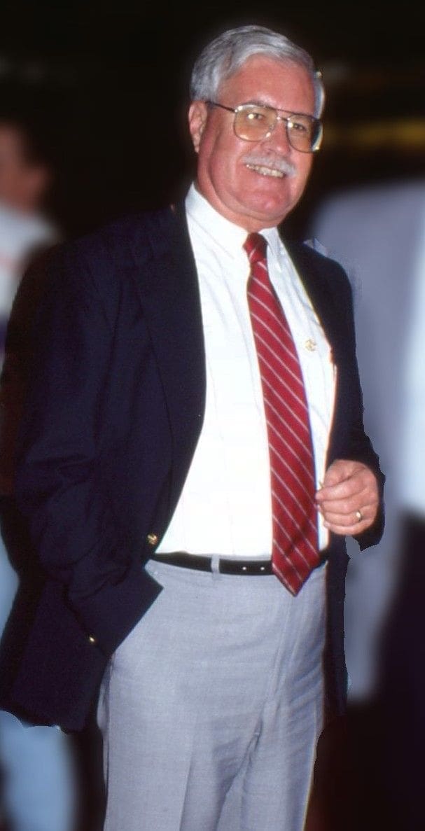 Business professional in blazer and tie.
