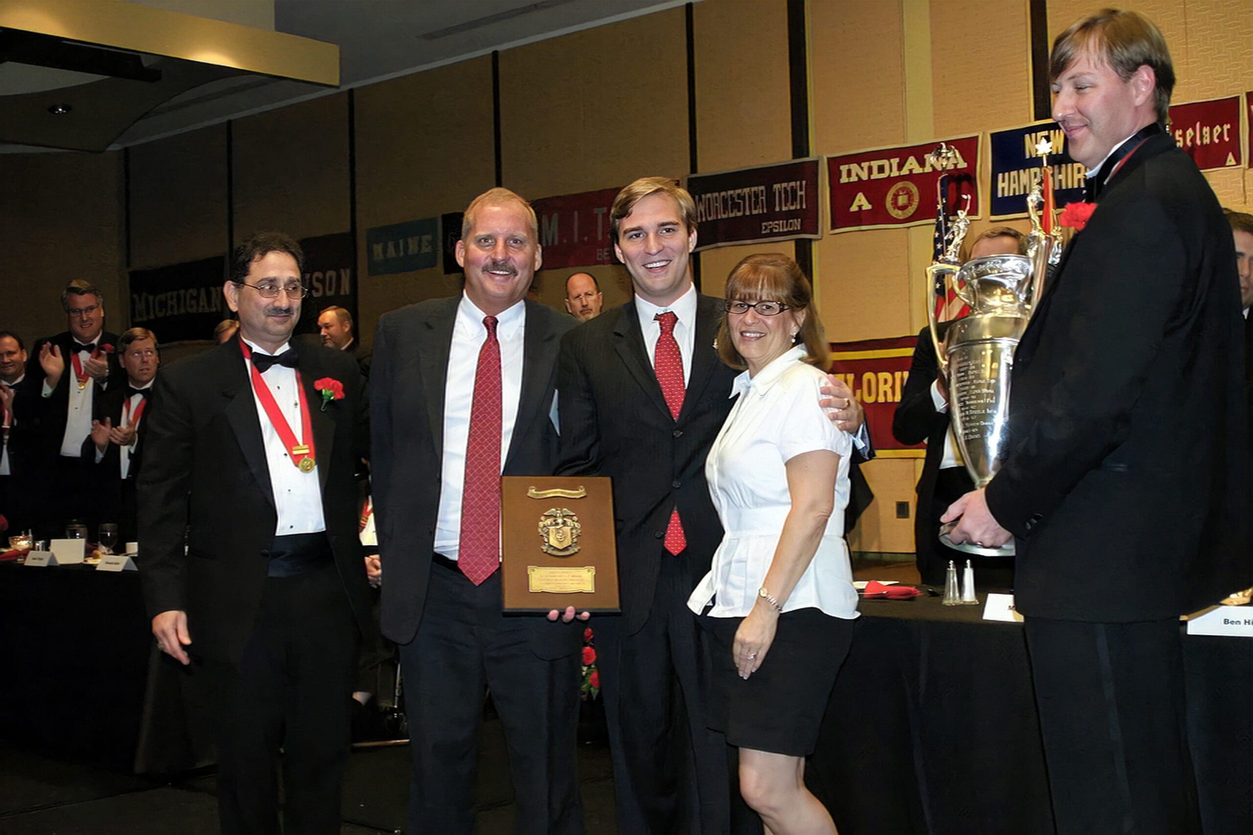 Group celebrating an award presentation at an event.