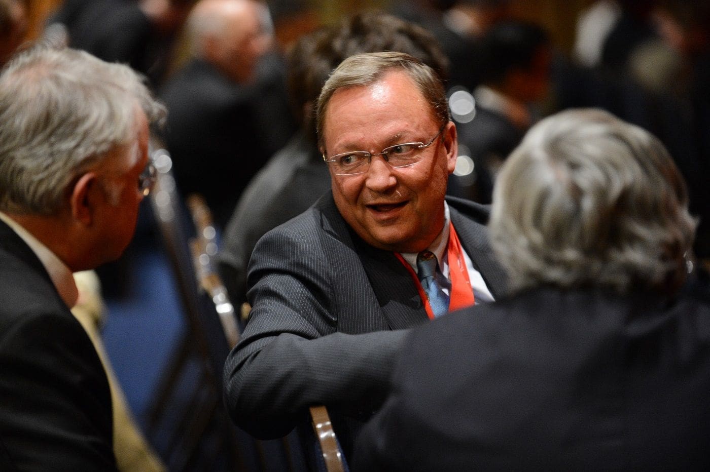 Businessman engaging in conversation at a conference.