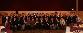 Group photo of business professionals at a conference.