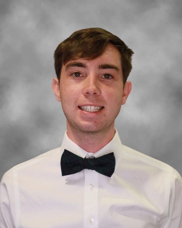 Young man in formal attire with bow tie.
