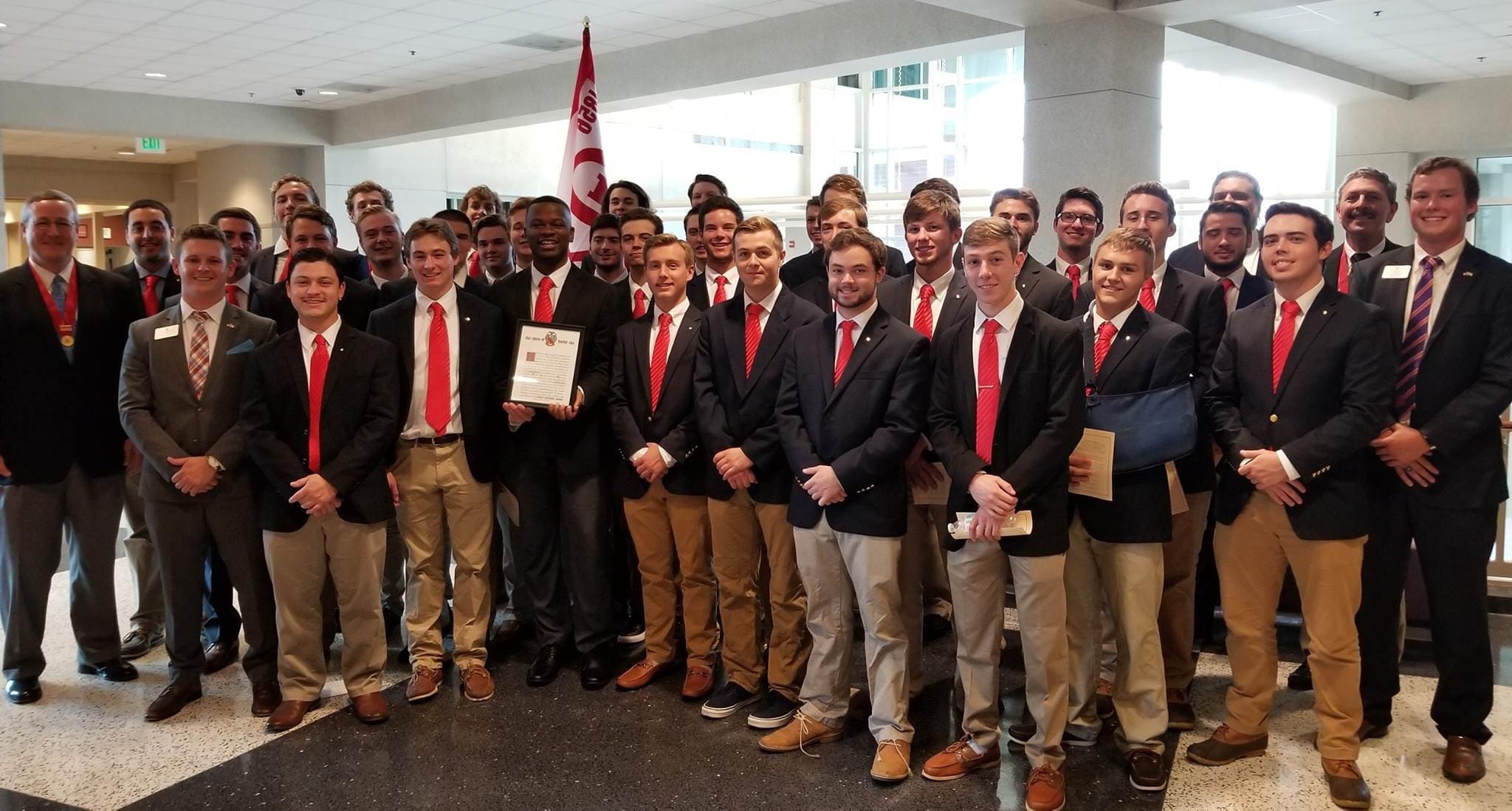 Eta Alpha Recolonization 2017 Group of students in suits celebrating an achievement.