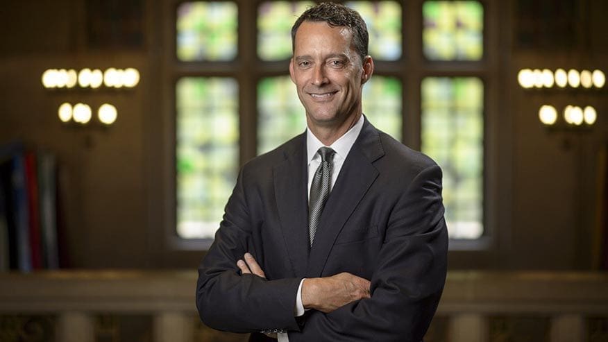 Business professional smiling in formal attire.