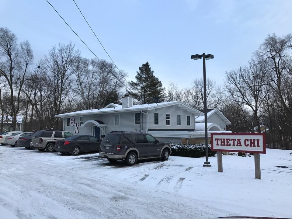 Theta Chi fraternity house in winter snow.