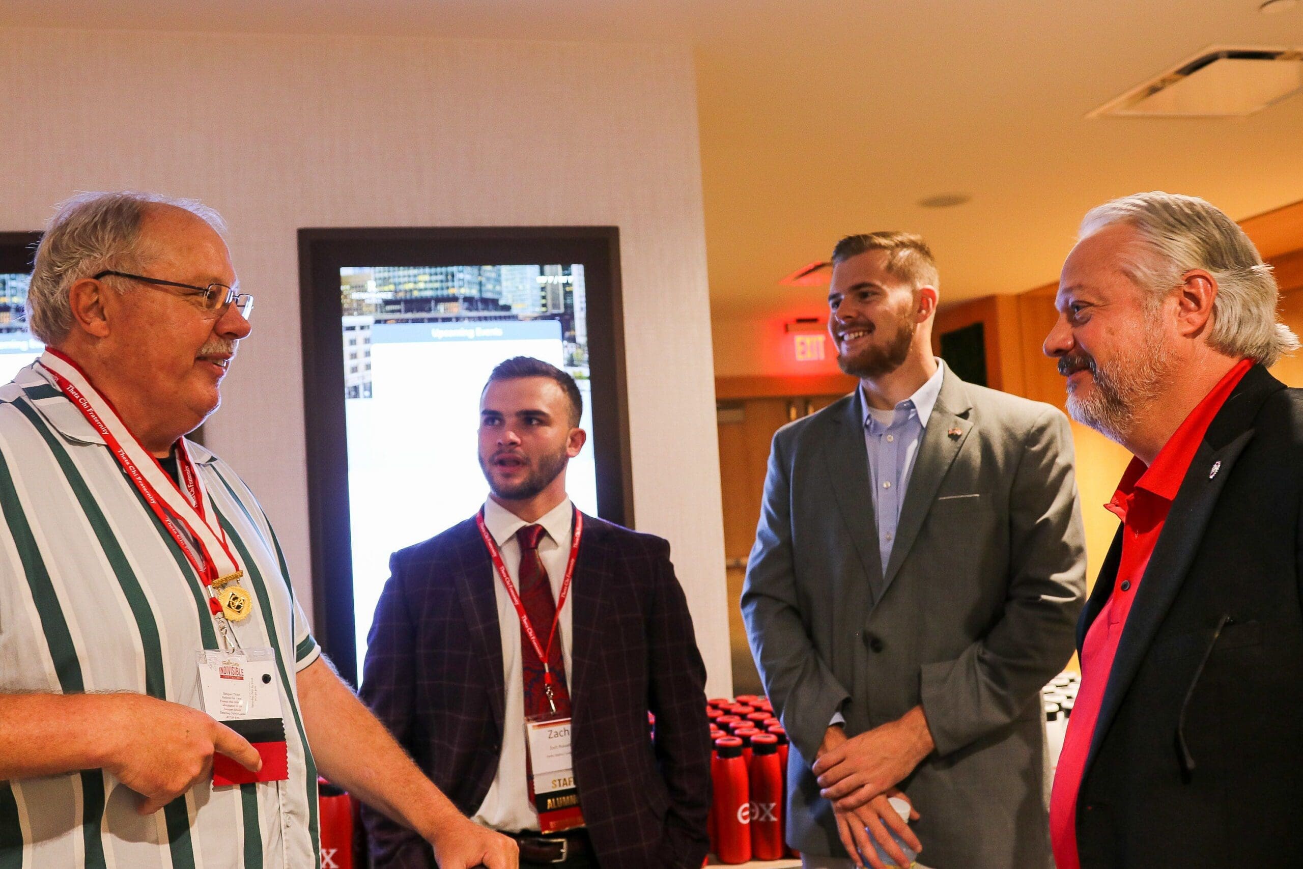Networking event with professionals engaging in conversation.