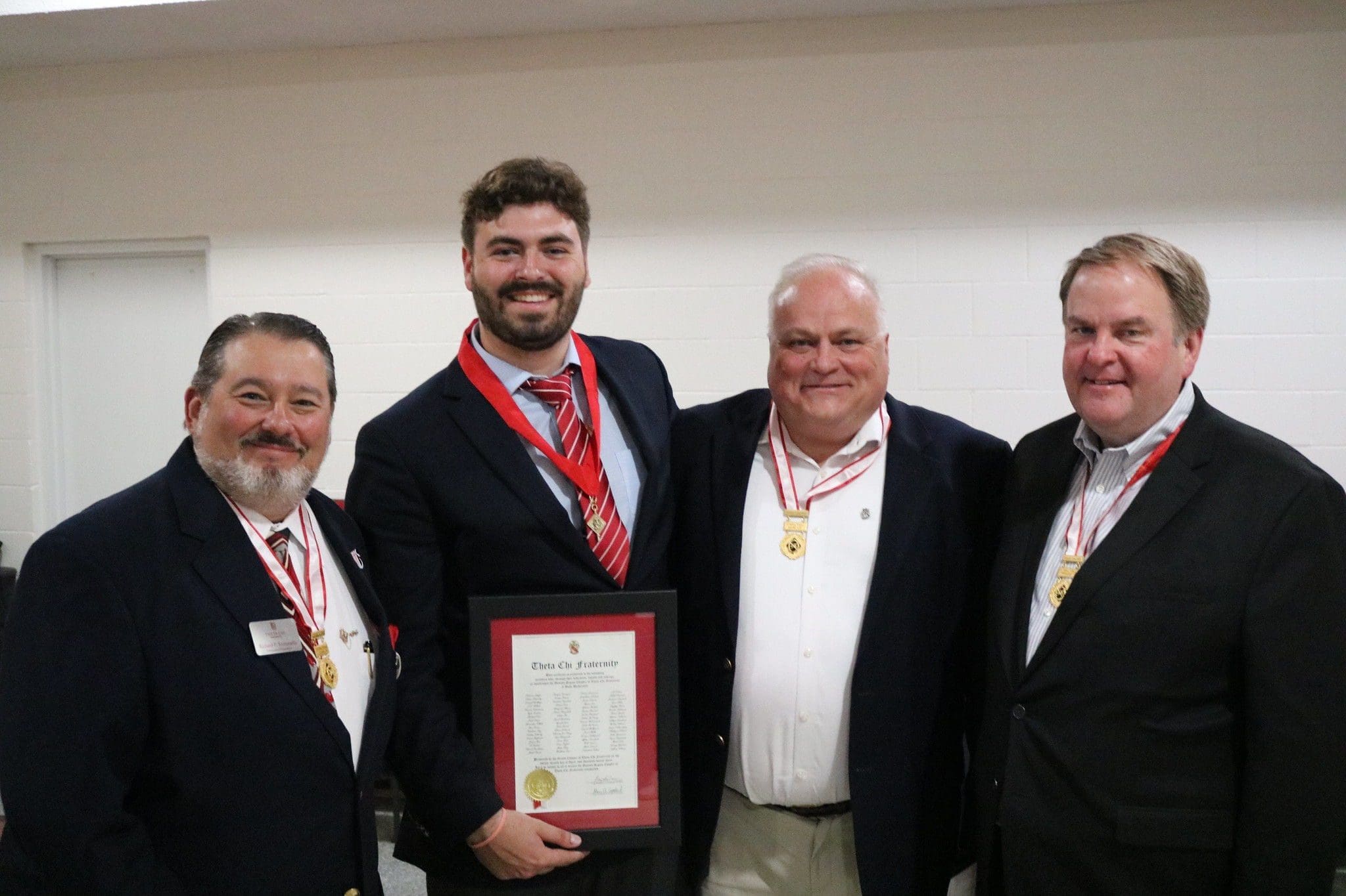 Group of men celebrating an award ceremony.