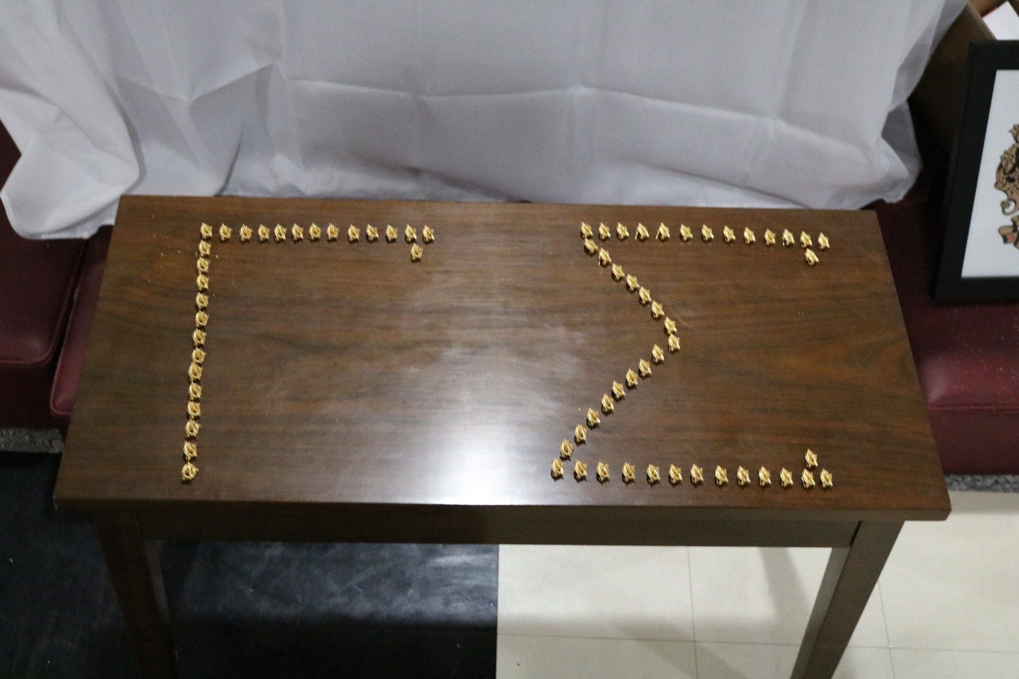 Decorative arrangement of gold coins on table.