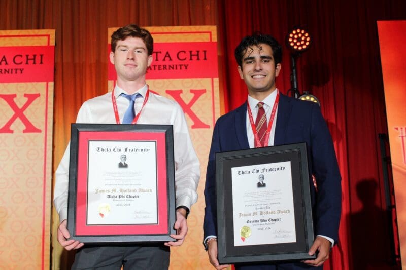 Students receiving awards at a Theta Chi event.
