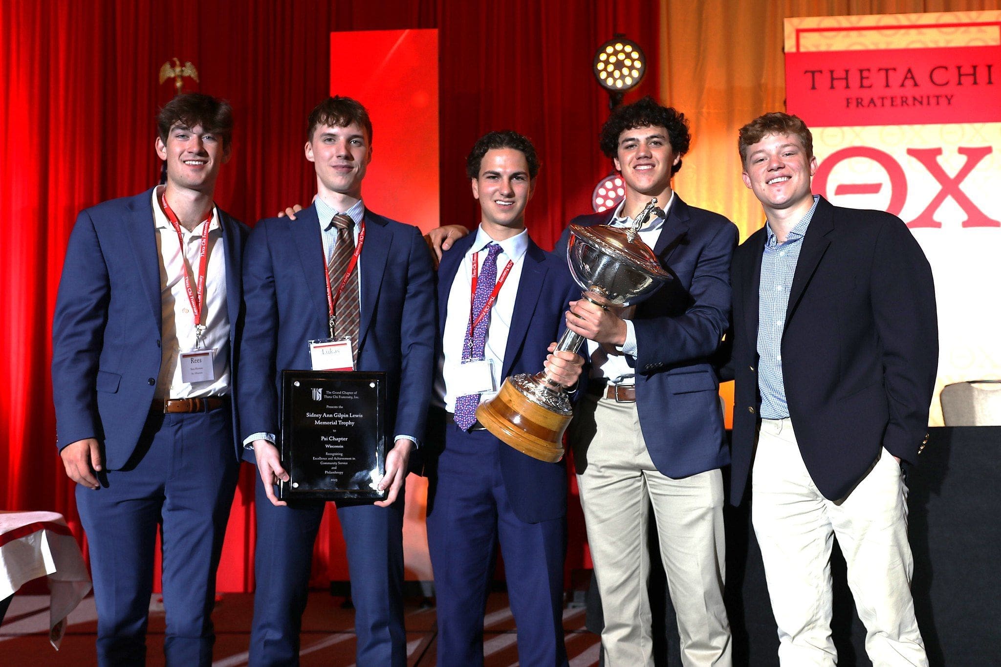 Group of award winners celebrating on stage.