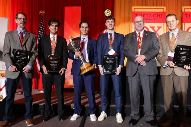Award winners holding trophies at a ceremony.