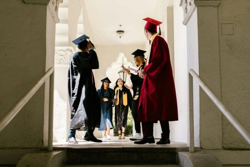 Graduates celebrating their achievement in caps and gowns.