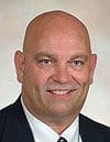 Professional man with a bald head and suit.