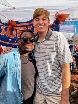 Two friends posing together at an outdoor event.