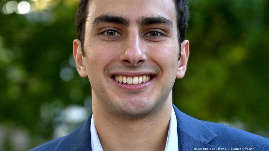Alexander Avakian - Epsilon - WPI Smiling man in a blue suit outdoors.