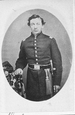 Civil War soldier in historical uniform portrait.