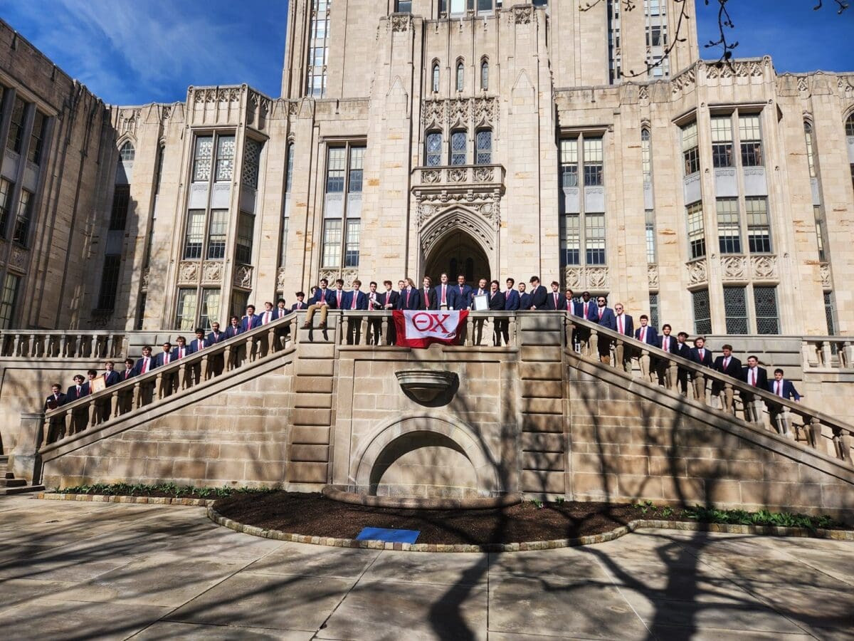 Group photo of students in front of historic building.
