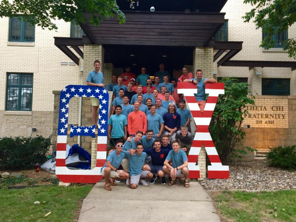 Group of fraternity members posing with letters.