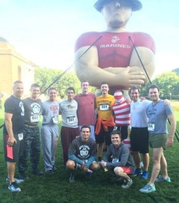 Group of runners with inflatable Marine mascot.