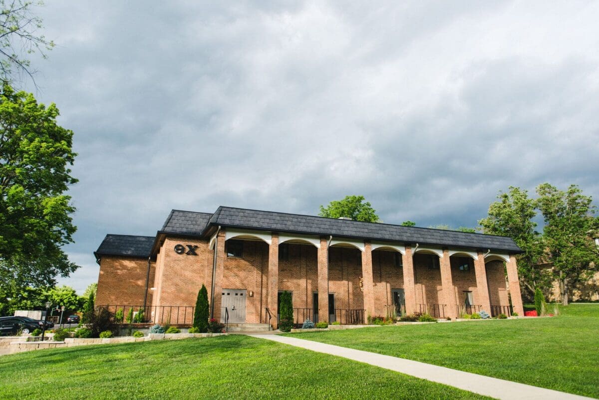 Historic brick building under cloudy sky.