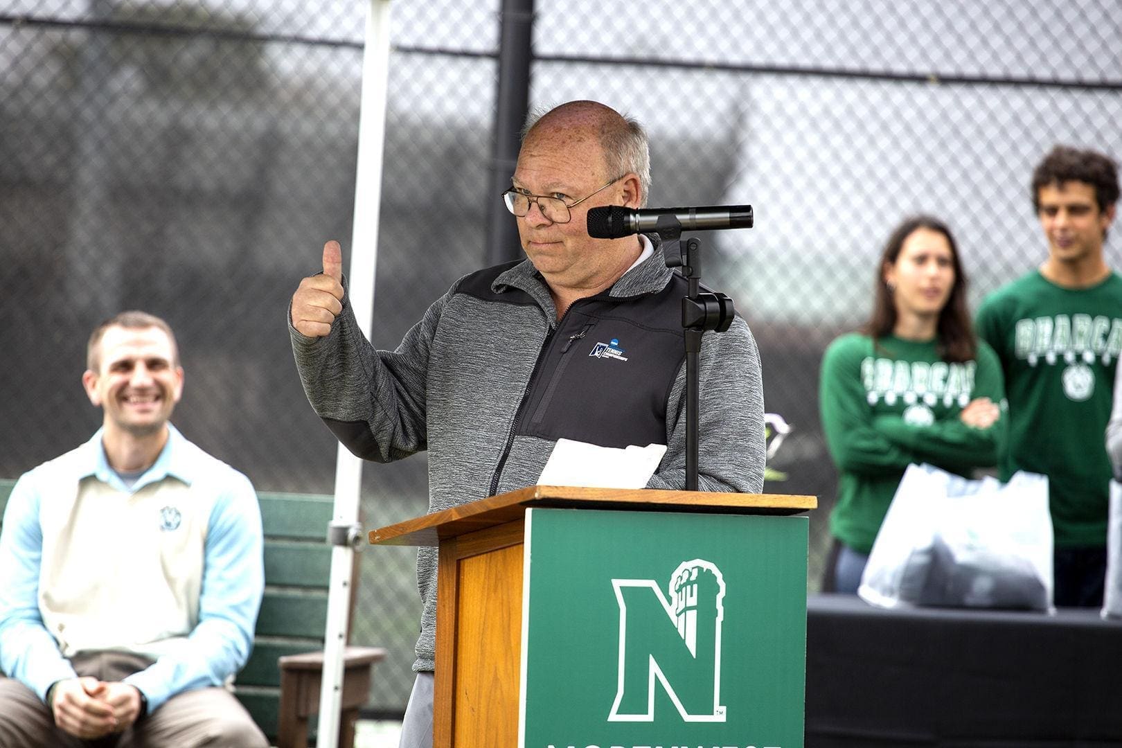 Mark Rosewell Speaker giving a thumbs up at outdoor event.