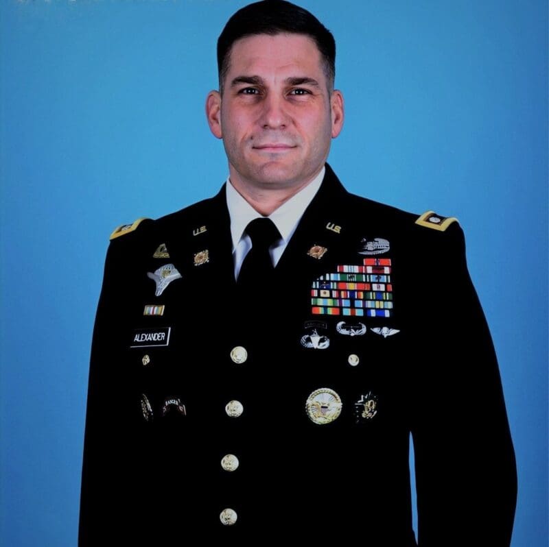 Military officer in uniform with medals and awards.