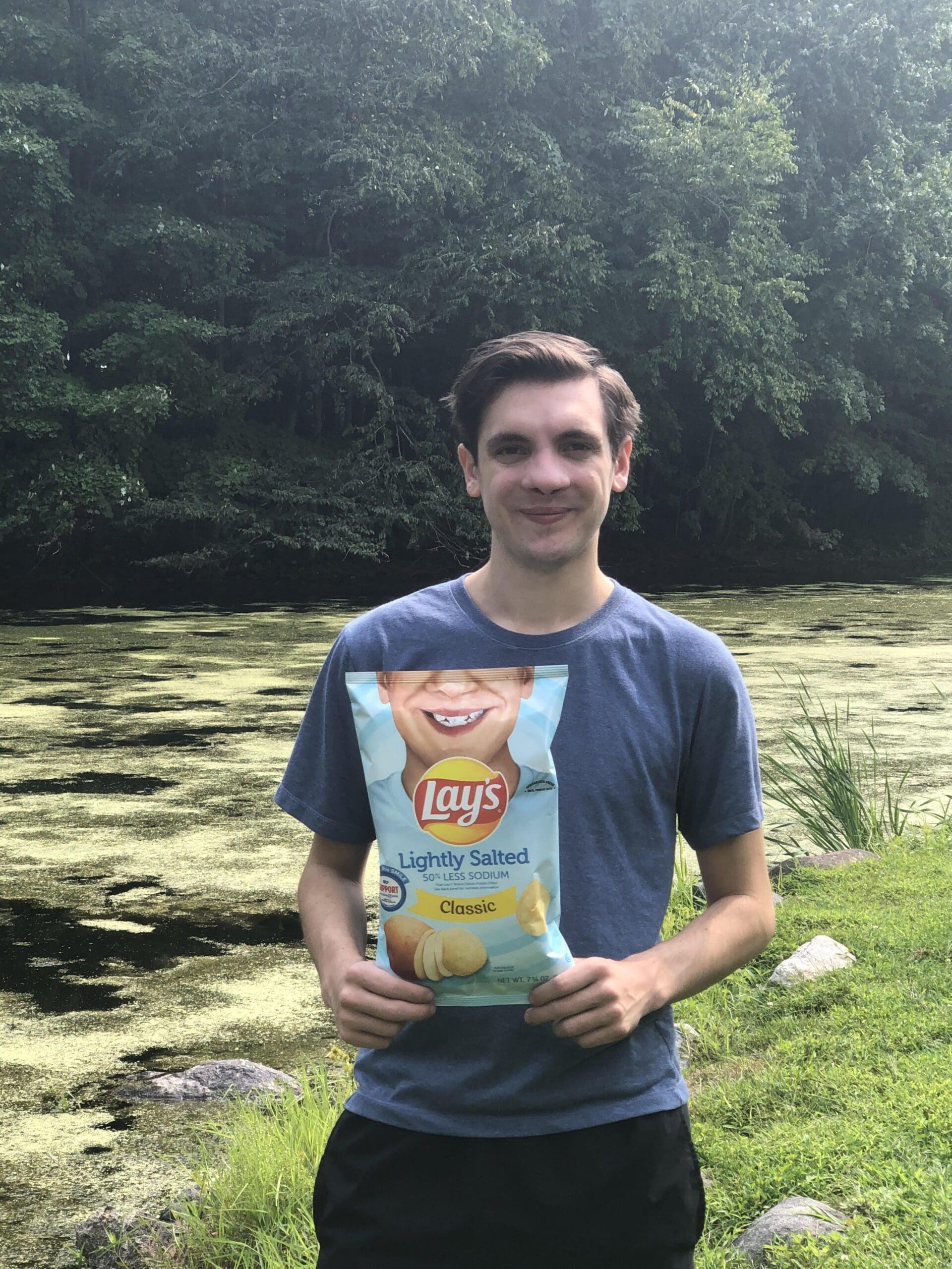 Eta - Rhode Island - Brady Hishmeh Young man holding Lay's lightly salted potato chips.