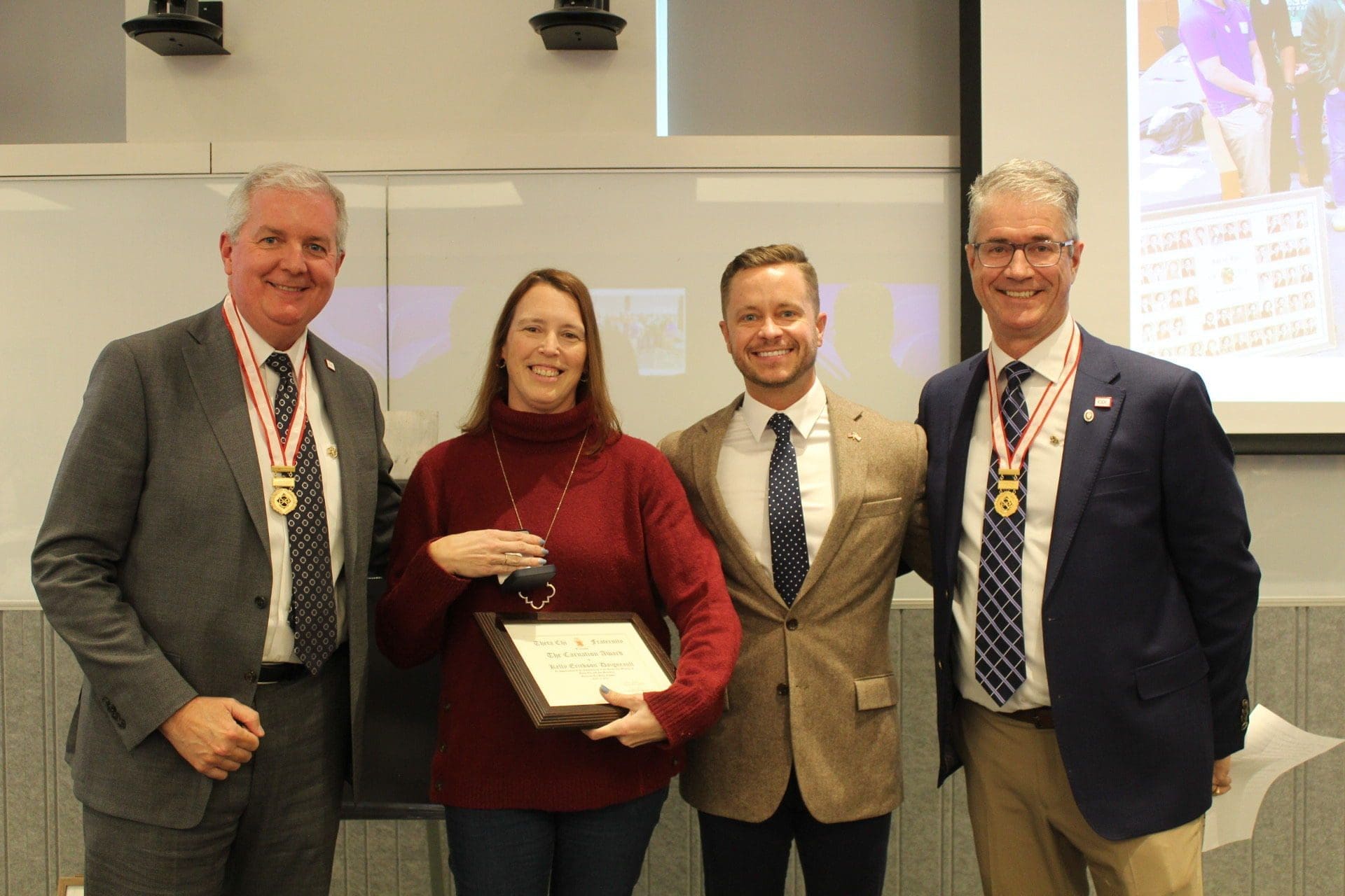 Award presentation ceremony with four participants.