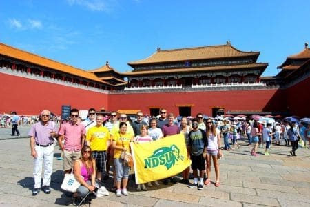 Group at Forbidden City with NDSU flag.