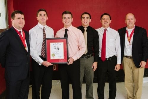 Group of young men holding an award certificate.