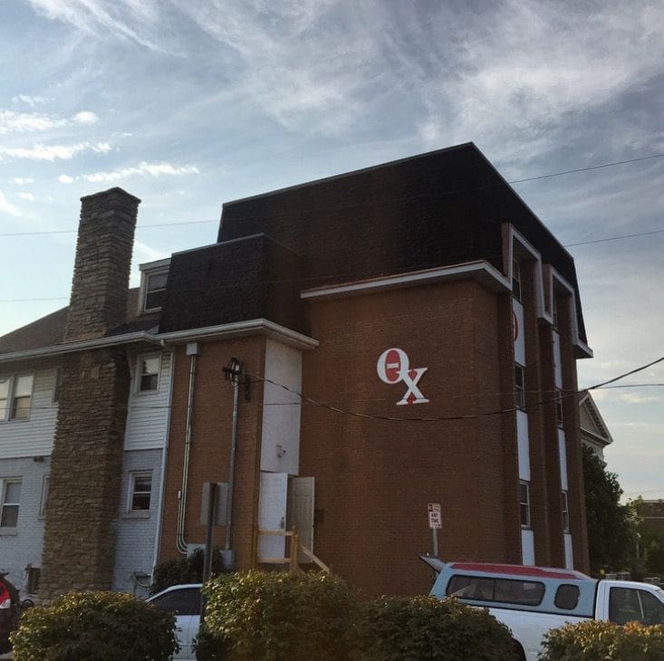 Brick building with Greek letters on facade.