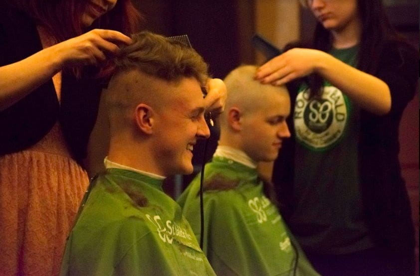 Lehigh - St Balricks - 2018 Men getting haircuts at a barbershop event.