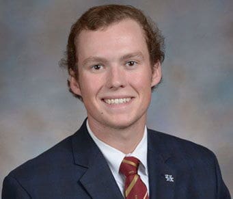 Blake Whitley Young man in formal attire with a friendly smile.