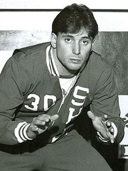 Athlete posing in vintage sports attire.