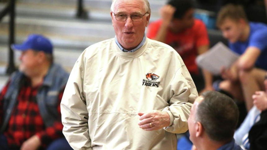 Bob Olson Older man in sports attire at basketball game.