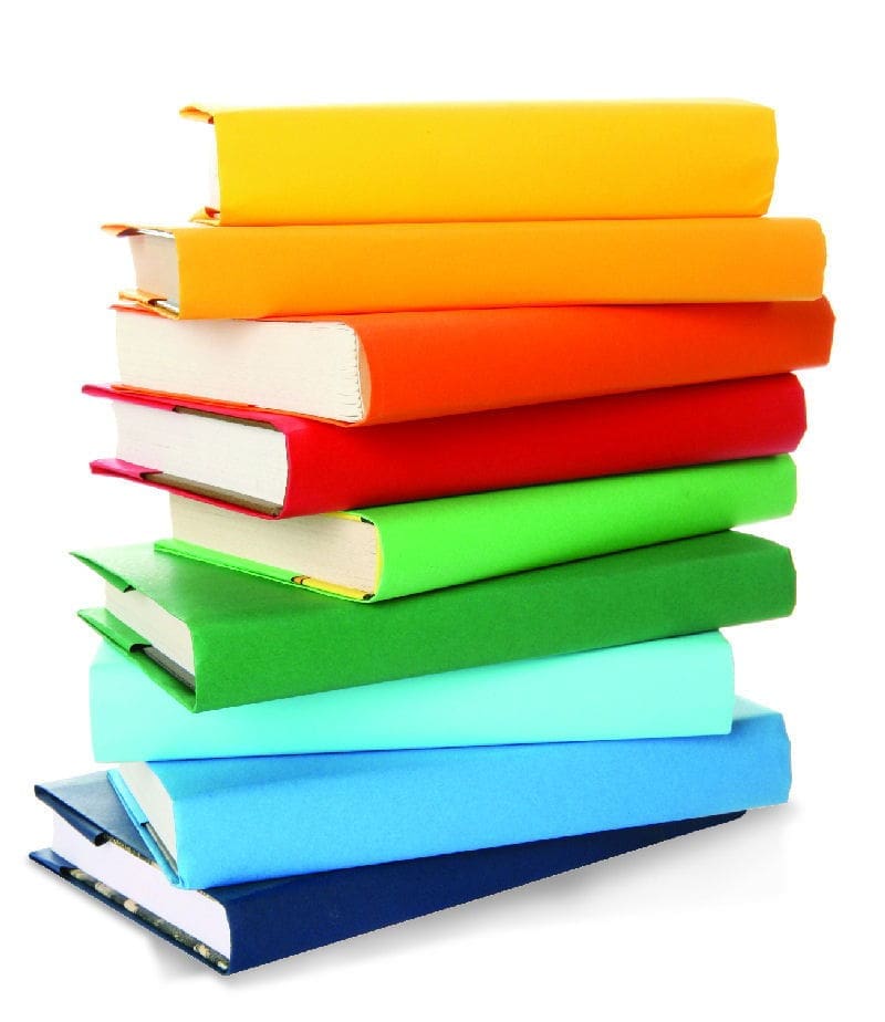 Colorful stacked books in various shades.