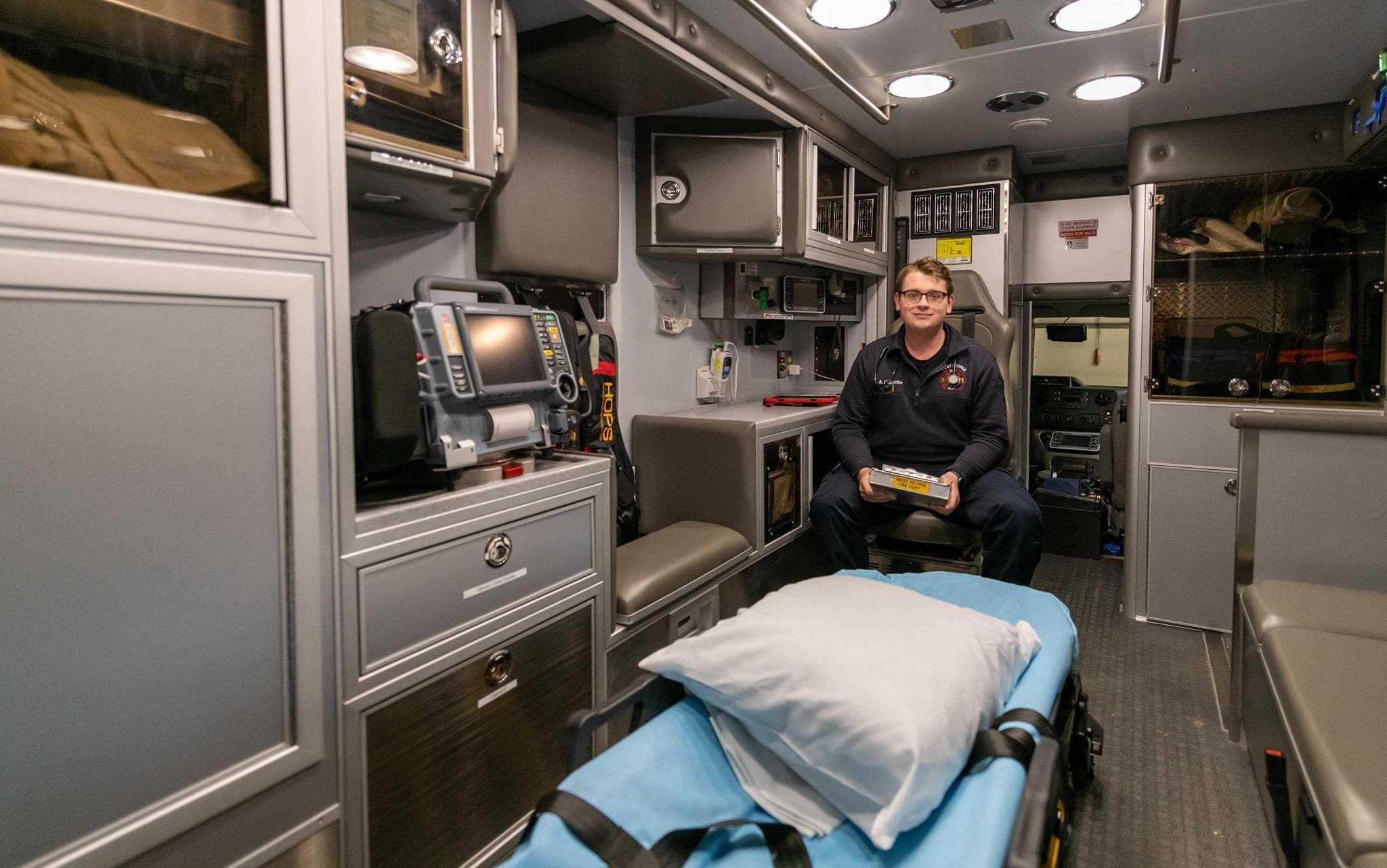 Aaron Coulombe - Bradley Paramedic inside modern ambulance with medical equipment.