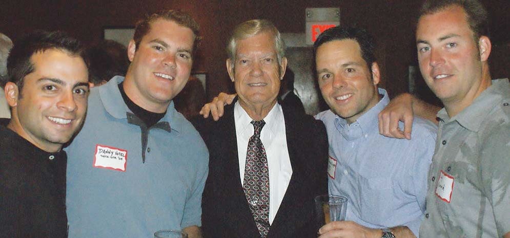 Buddy Davis Three men smiling together at a social event.
