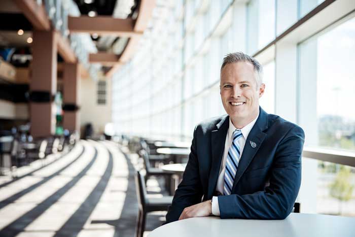 Business professional smiling in modern office setting.