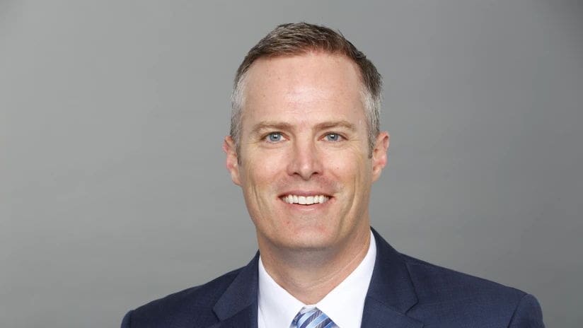 Burke Nihill Professional man in a suit smiling confidently.