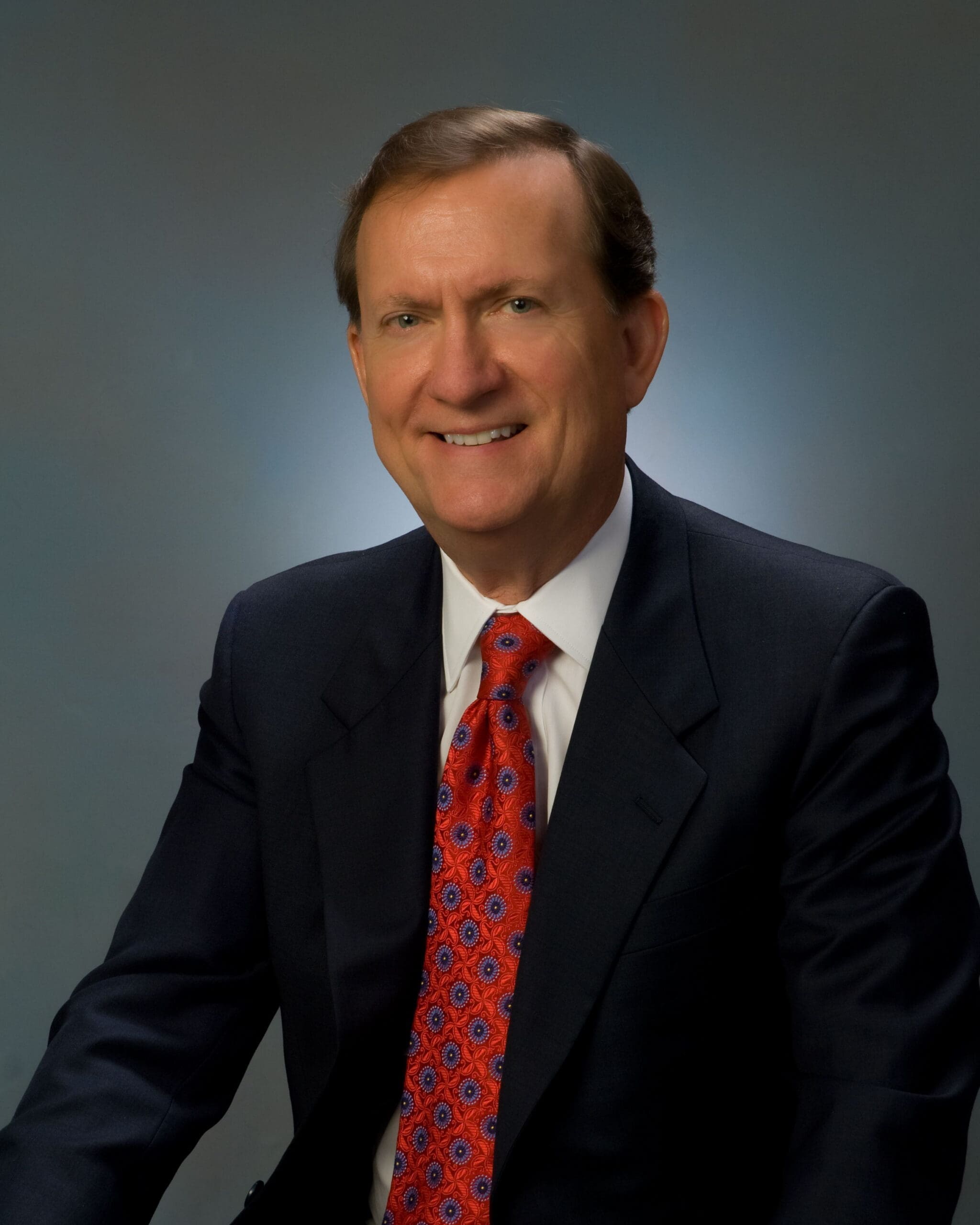 Professional man in suit with red tie.