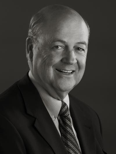 Professional man smiling in a suit portrait.