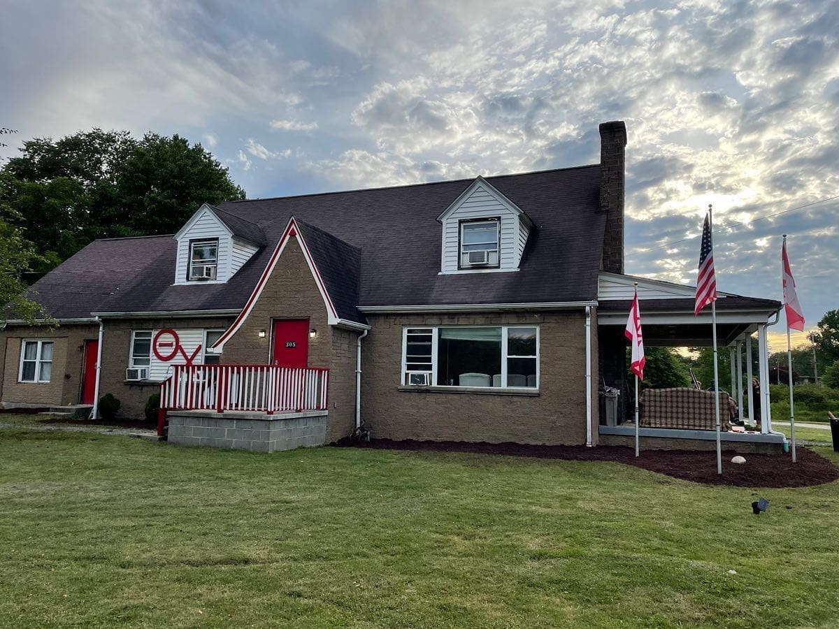 Charming house with flags and a red door.