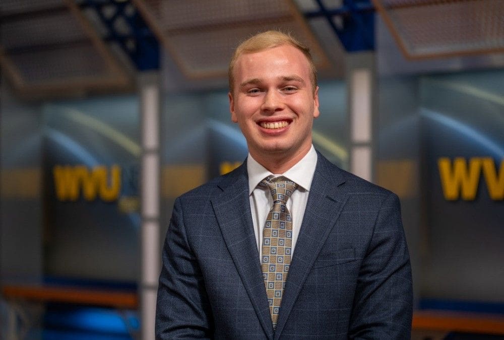 Hayden Keener Smiling man in a suit with a professional background.
