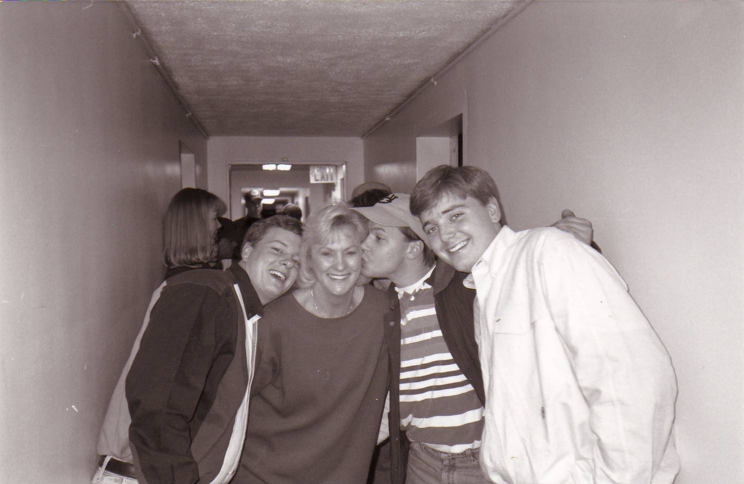 Group of friends posing in a hallway.
